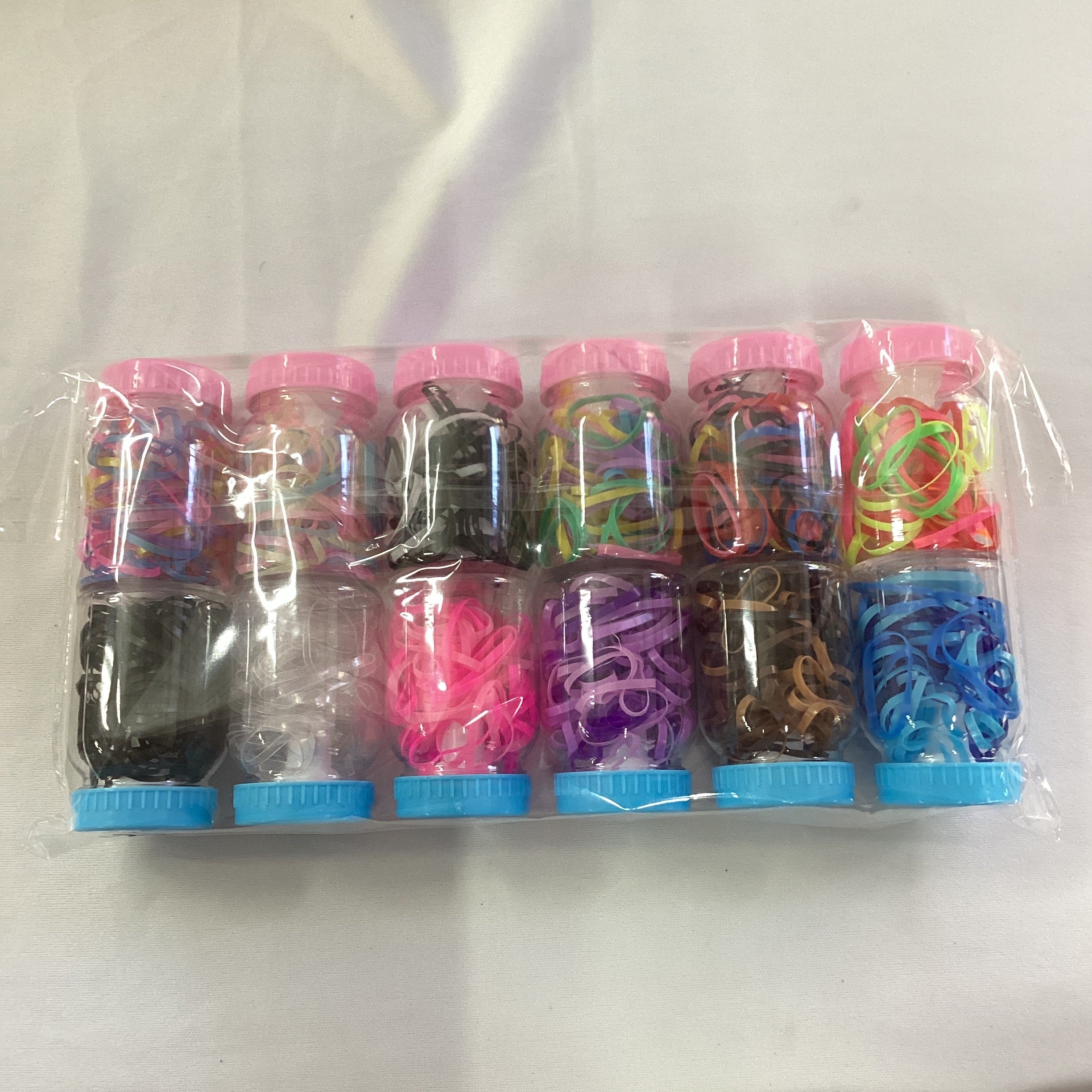 LIGAS DE LATEX EN ESTUCHE DE BIBERÓN SURTIDO EN COLORES POR MAYOREO
