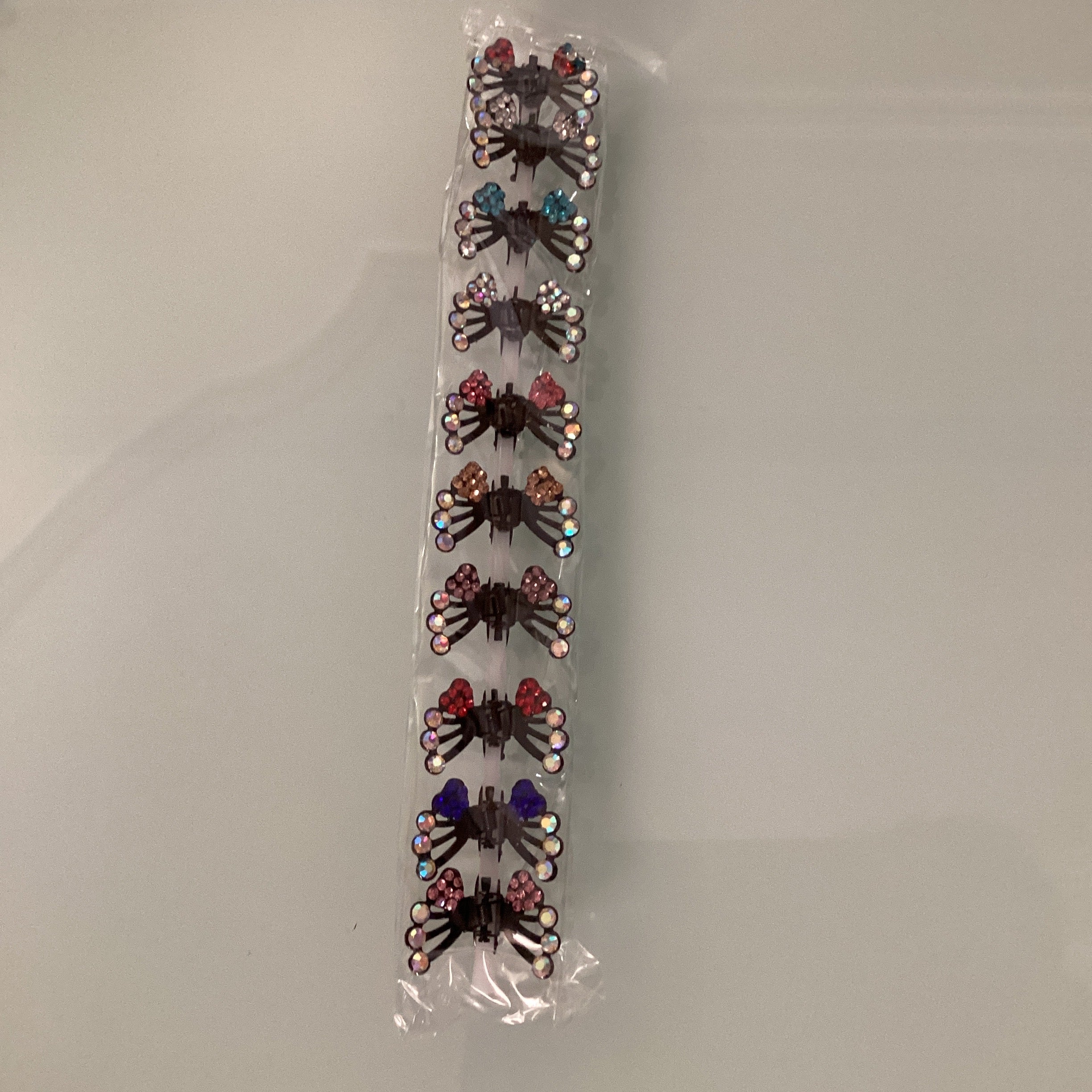 PINZA MINI METÁLICA DECORADA MARIPOSAS SURTIDA EN COLORES POR MAYOREO