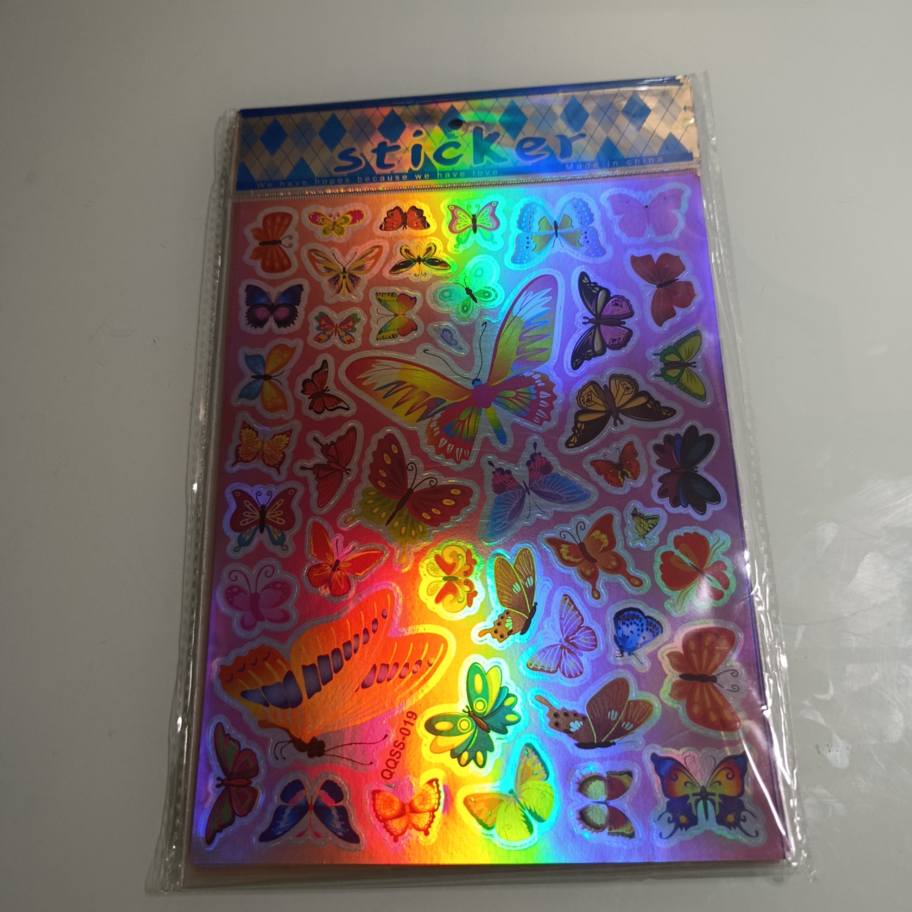 STICKER CALCOMANIA LASER METALICA 28X17.5 CM POR MAYOREO