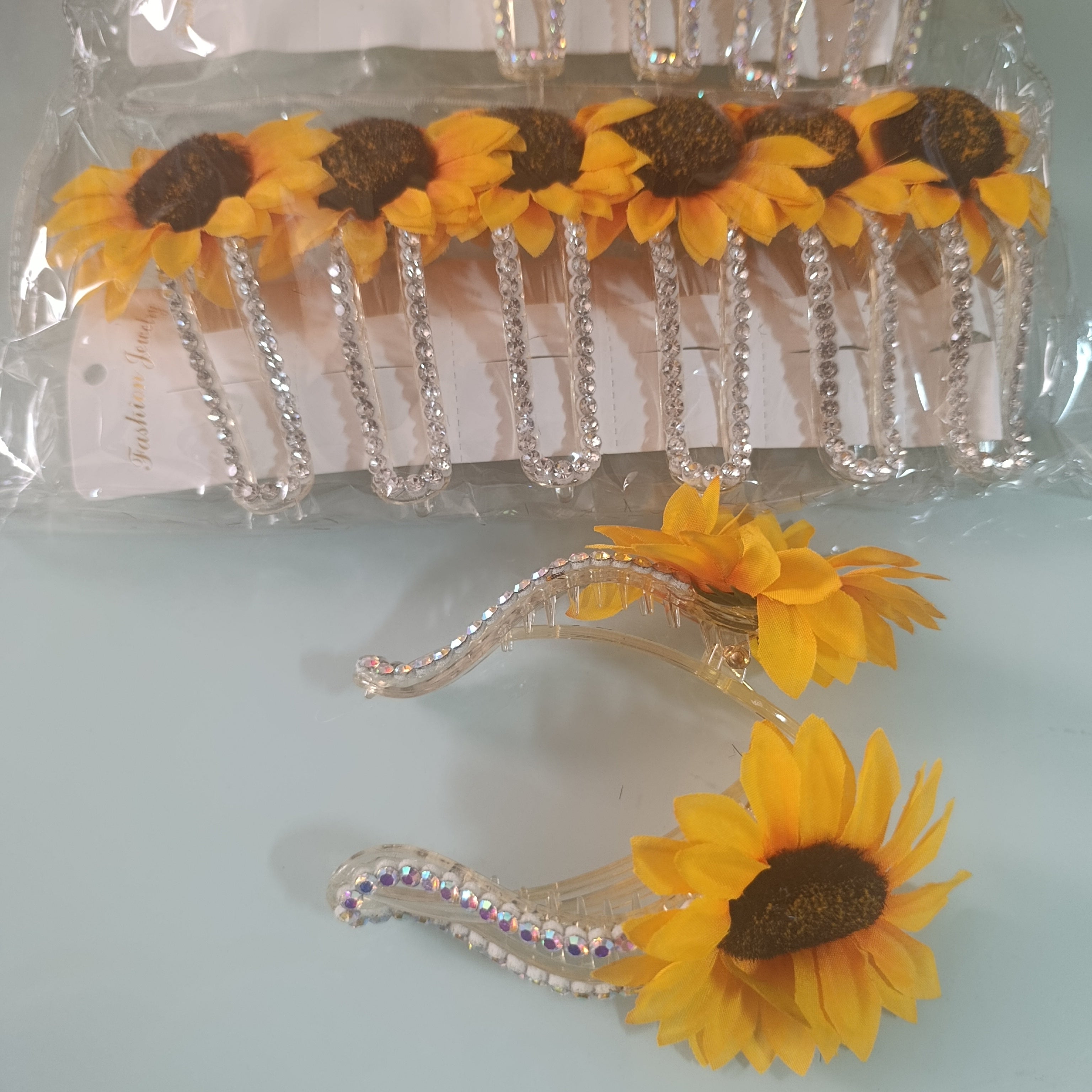 PINZA TIPO PICO PARA EL CABELLO 14 CM DE LARGO DISEÑO GIRASOLES POR MAYOREO CON 12 PZAS